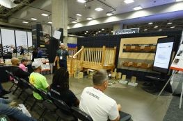 Outdoor living and decking pros attending a demonstration at Deck Expo
