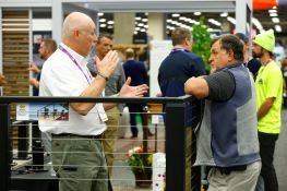 Deck Expo attendees at a decking and railing exhibitor's booth