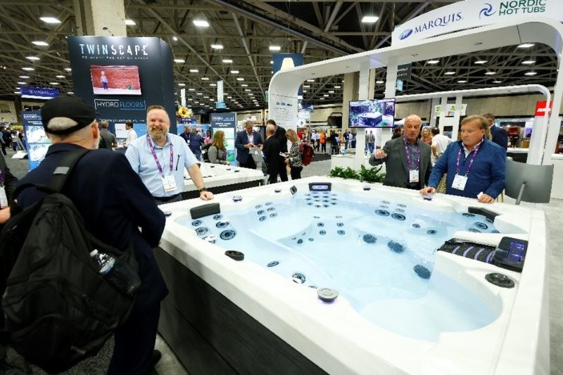 PSP Expo attendees looking at a spa hot tub on the show room floor