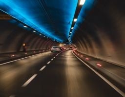 Cars driving through a futuristic tunnel